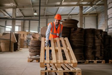man-working-with-heavy-wooden-materials_23-2148976279